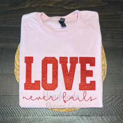 Love Never Fails Embroidered Applique Garment - Youth/Adult